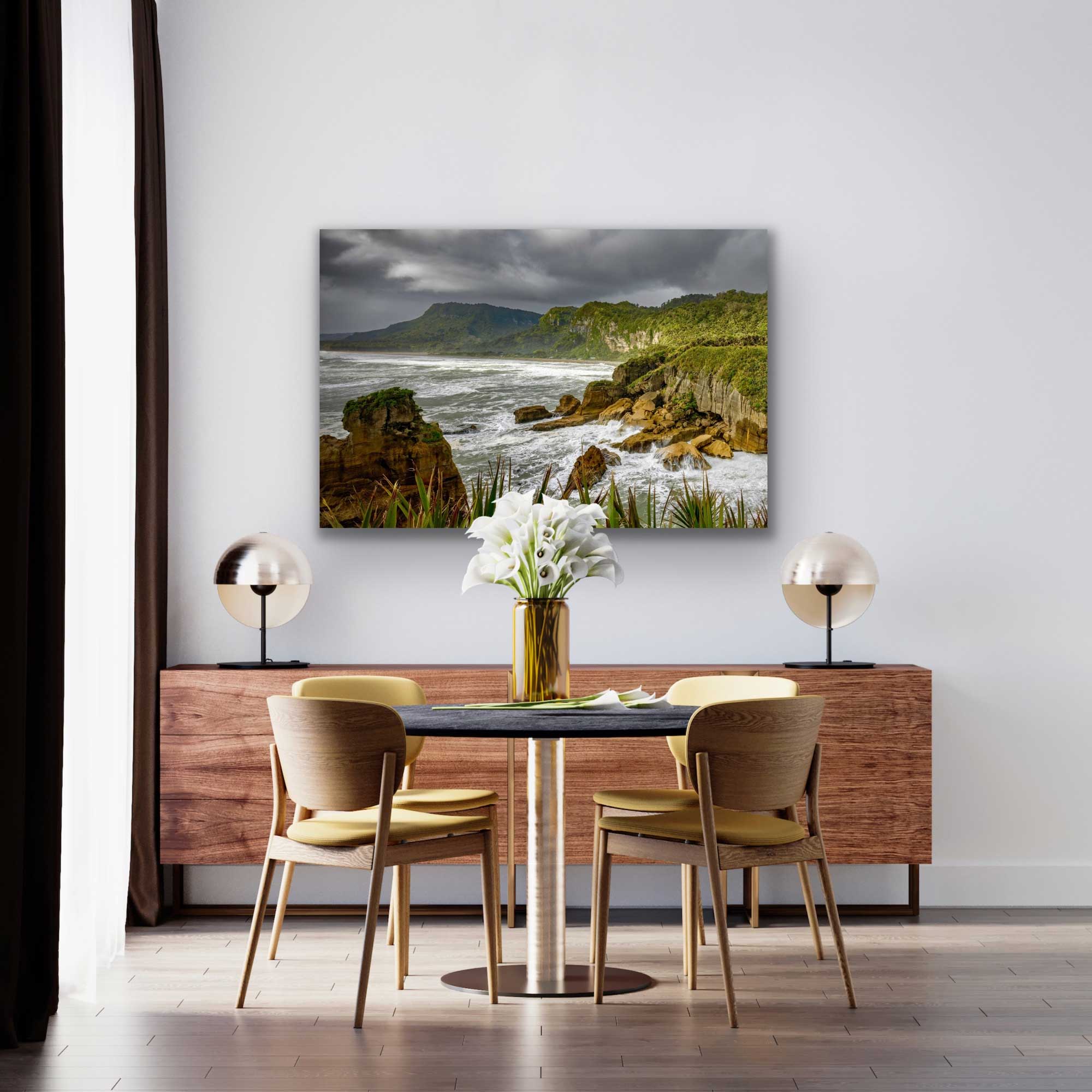 NZ rugged West Coast landscape photograph in situ, hung on the wall above coffee table.