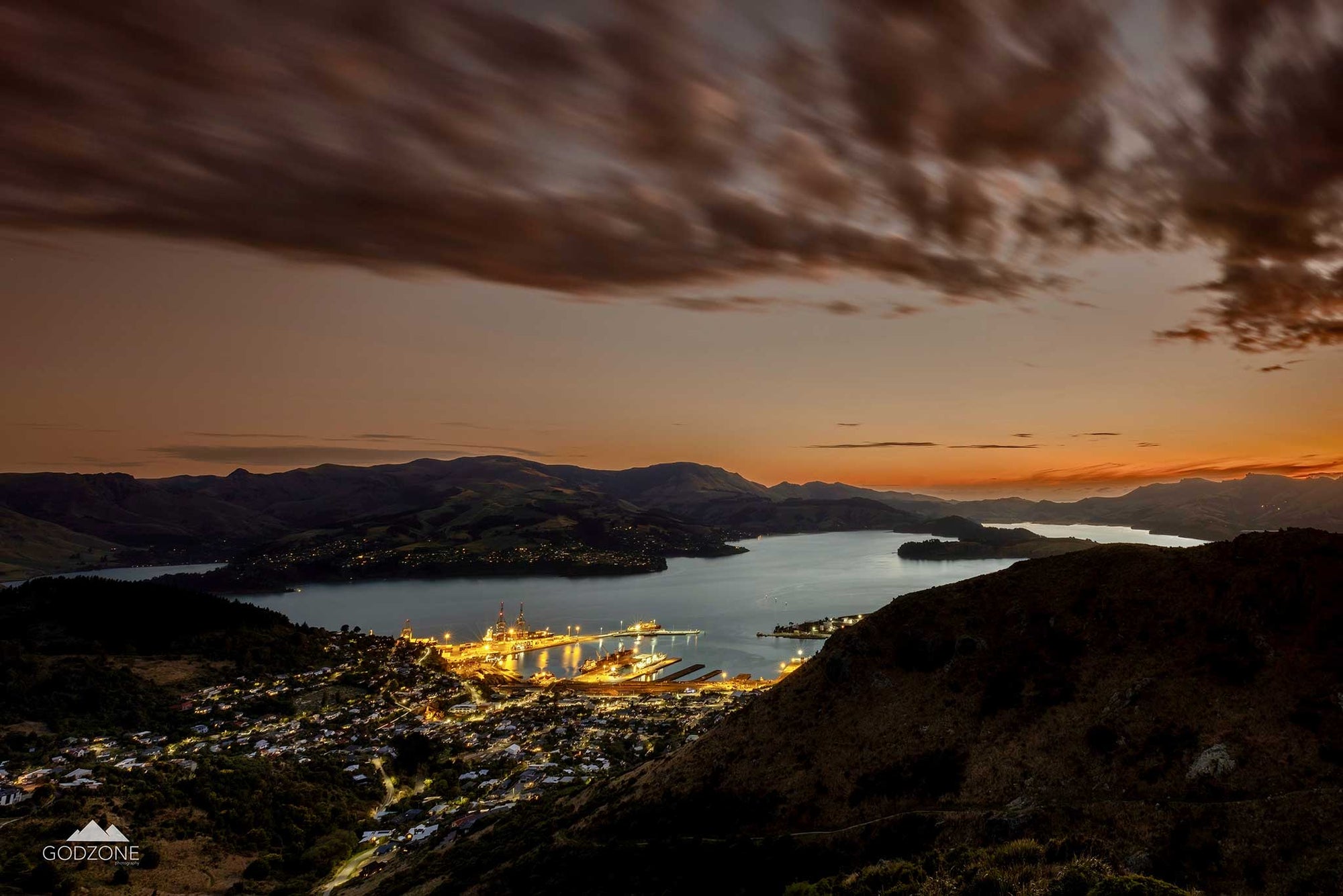 Panoramic aerial photograph of Lyttelton Harbour at sunset. Christchurch cityscape affordable artwork. New Zealand landscape photographic prints for sale.