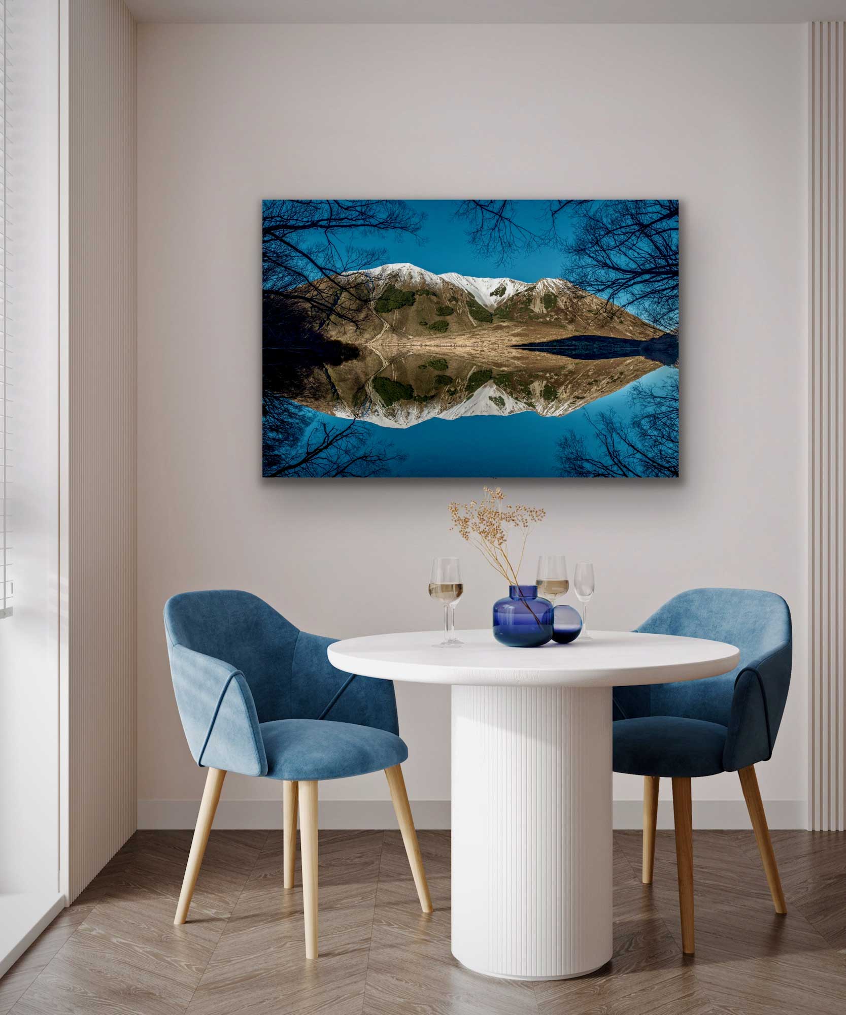 Stunning reflective Lake Pearson photograph presented in situ above a small table and chairs. Beautiful blue tone photographs for interior design.