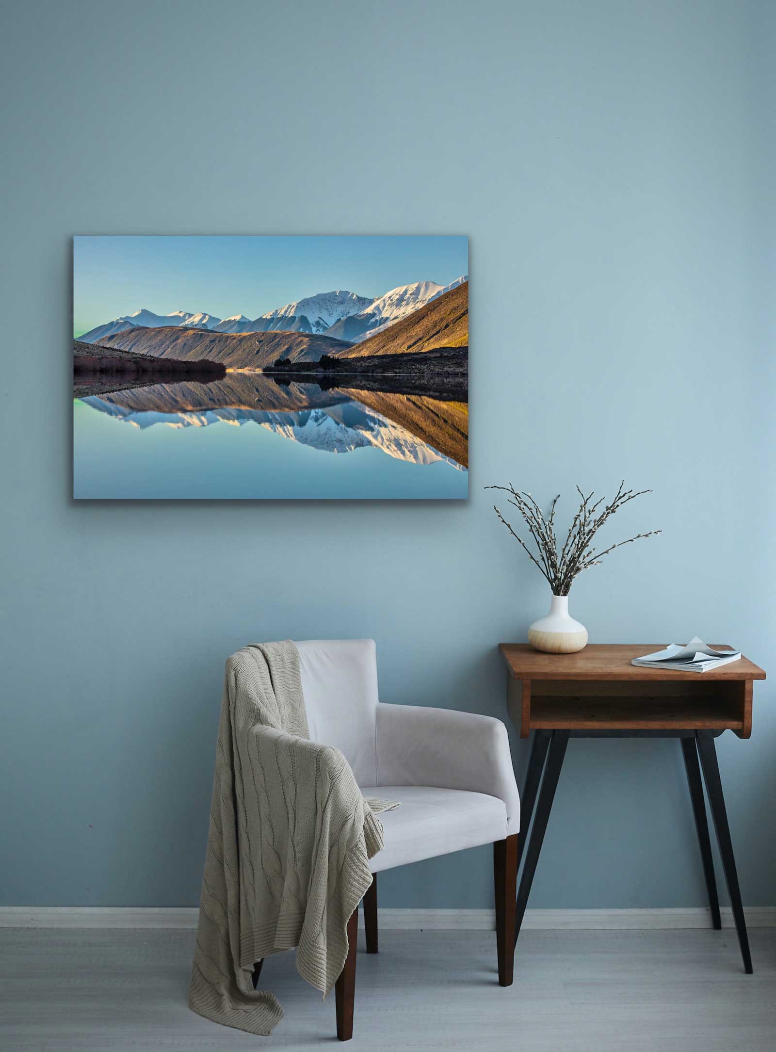 Reflective Lake Pearson photograph hung on the wall above a chair and small desk. Interior design art, see it in situ.