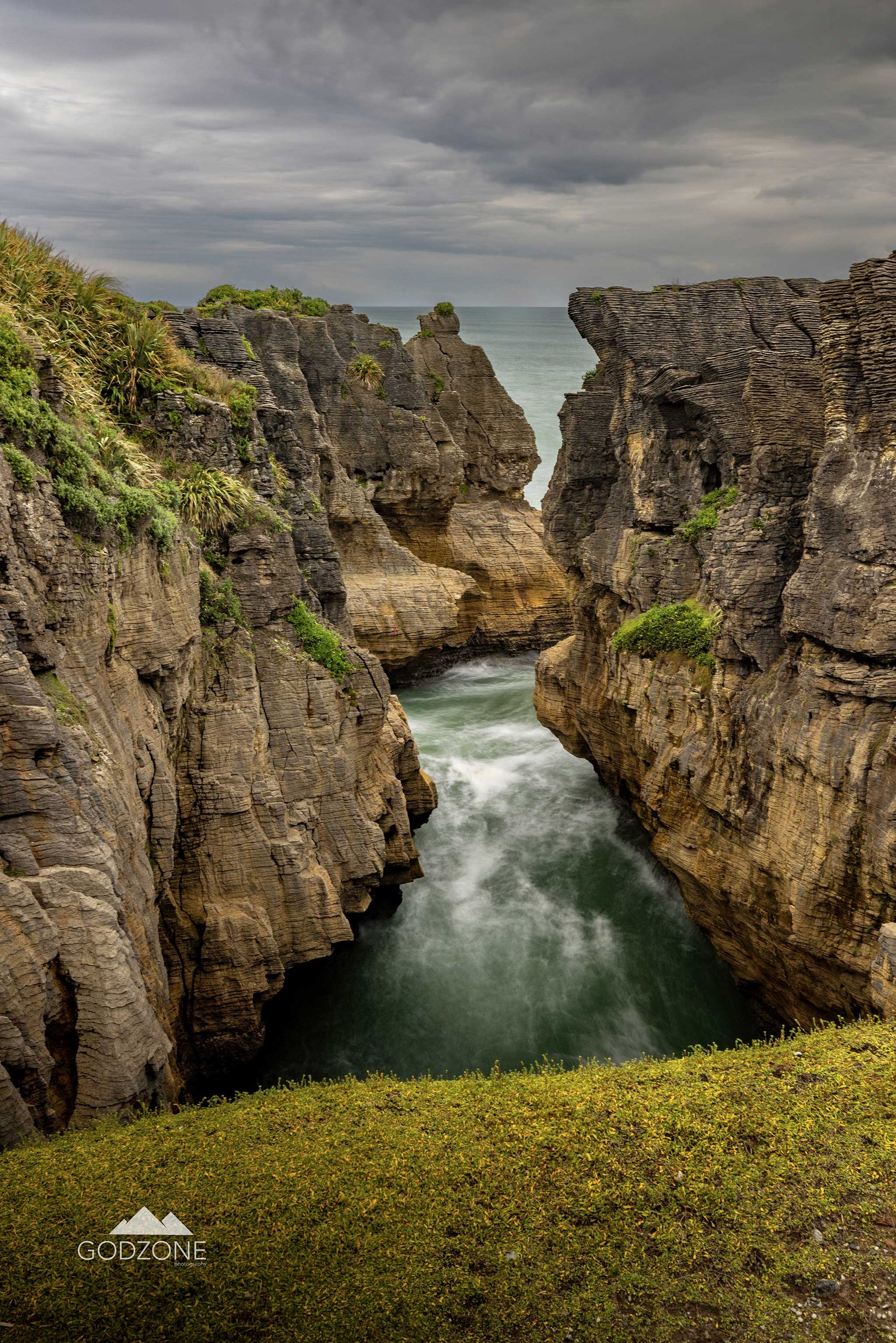 Tall portrait photograph of the surge pool at Punakaiki on the West Coast of New Zealand's South Island. NZ south island landscape photography for sale.