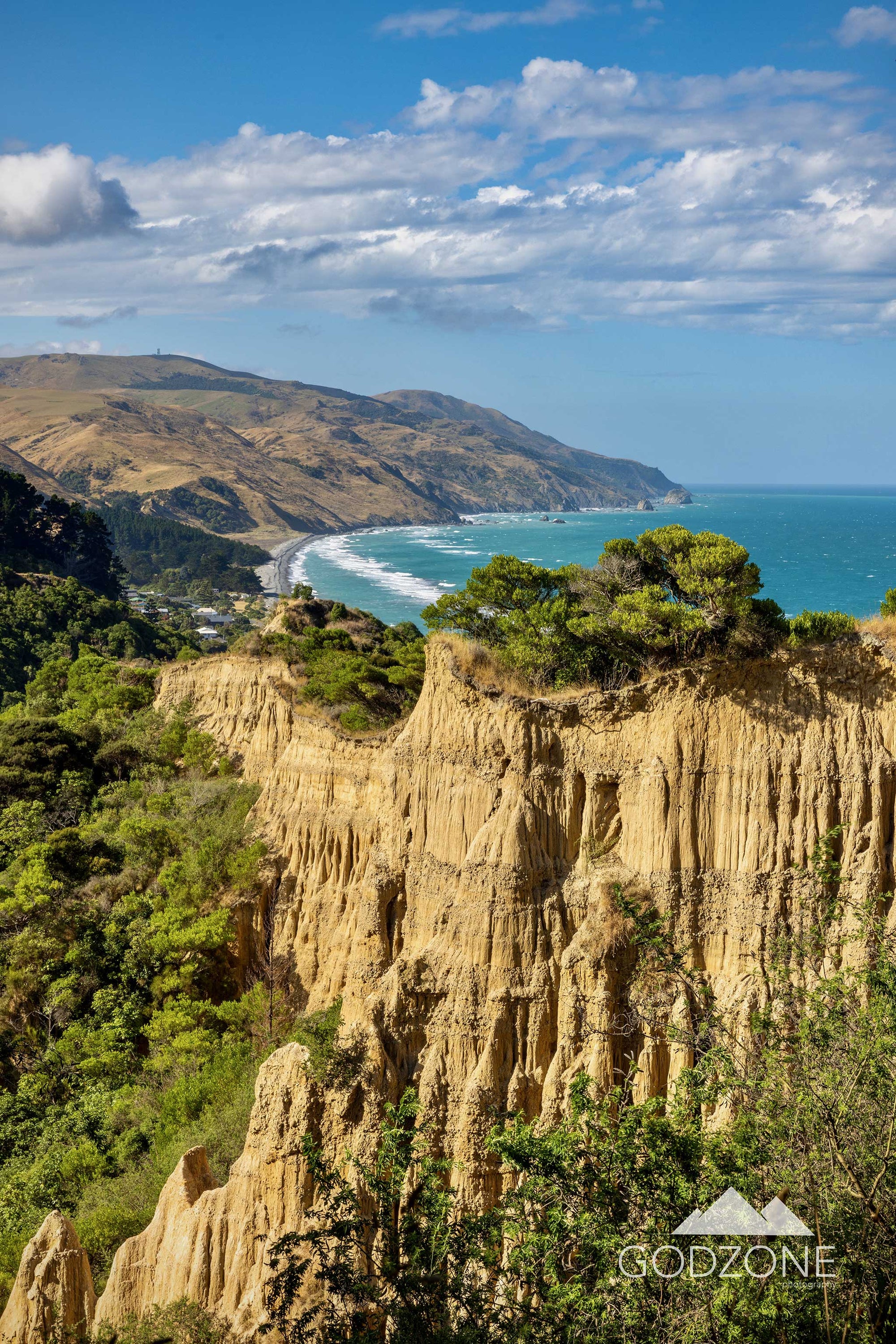 Sunny portrait photograph of Gore Bay's famous Cathedral Cliffs  in North Canterbury, South Island New Zealand.