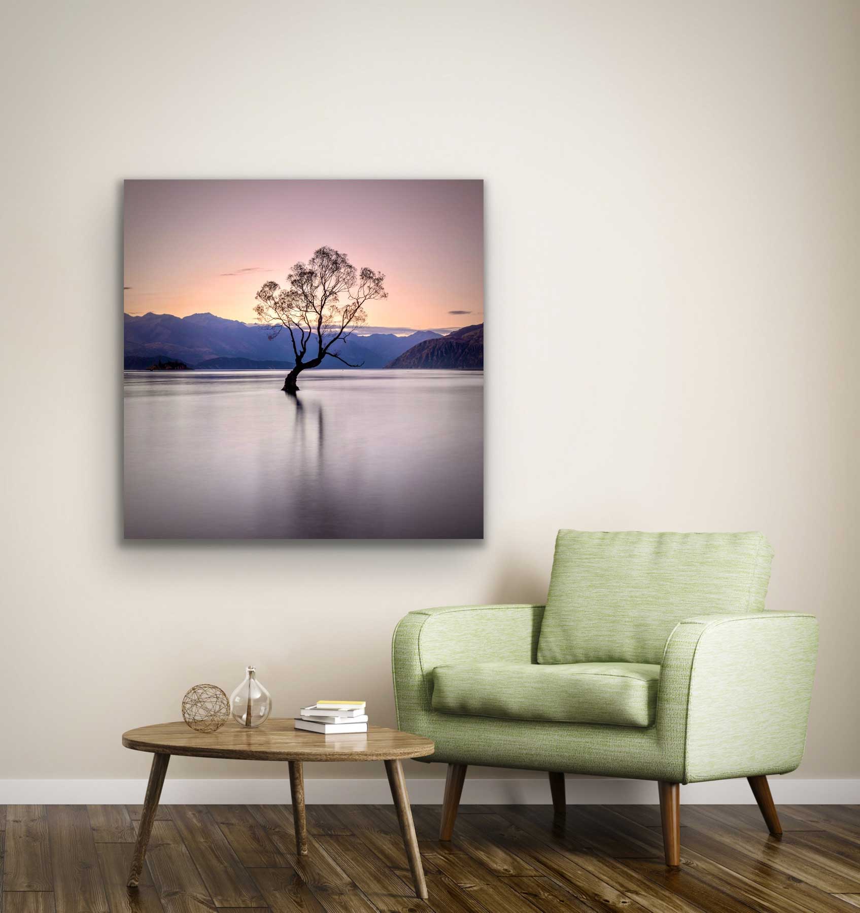 Square landscape photograph of the famous Wanaka tree on the wall by chair and coffee table. NZ interior design artwork.
