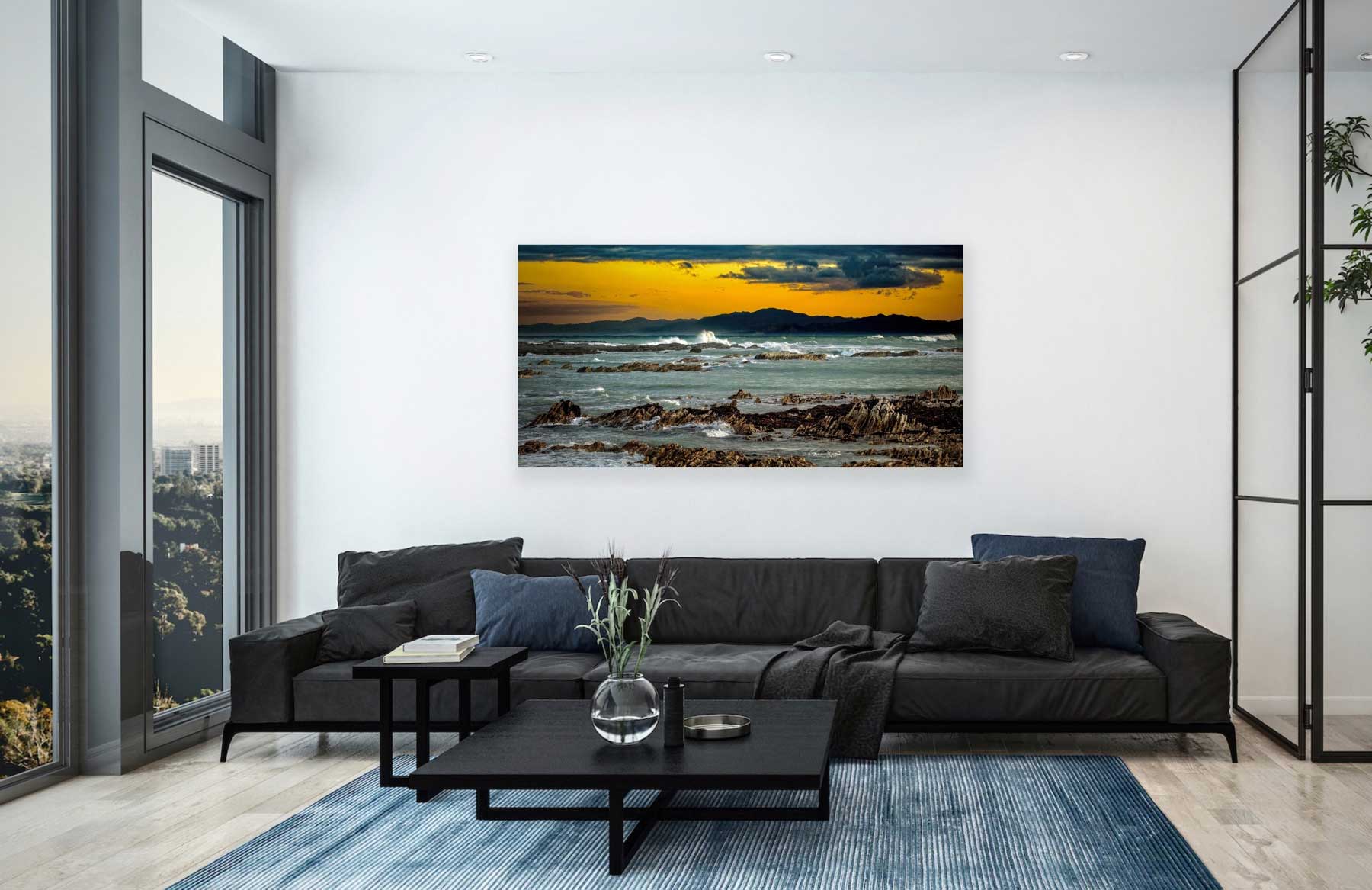 South Bay Kaikoura II photograph on display in situ, hung above lounge seating arrangement. NZ rugged beach art interior design.