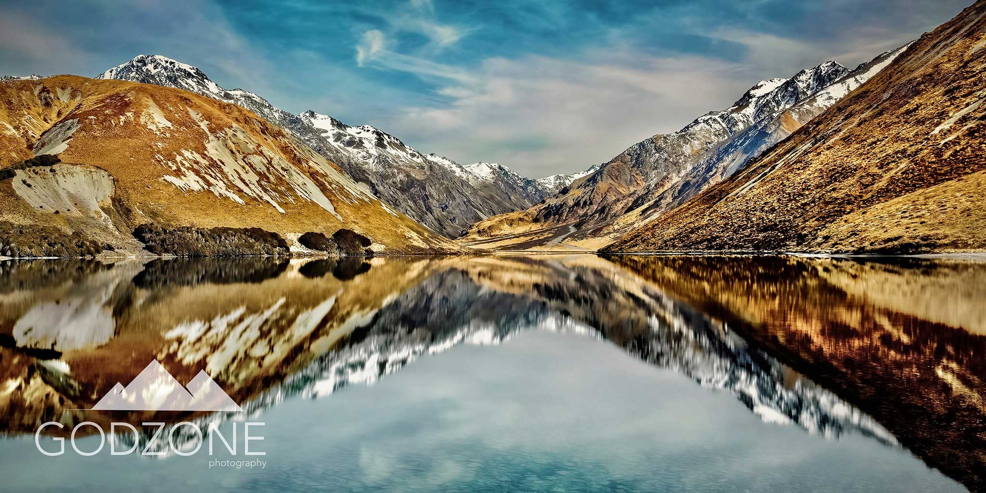 Bright reflective lake photograph of Lake Tennyson in Canterbury, New Zealand. Glacial mirror lake photographs NZ. Artwork with blue and mustard colours. 