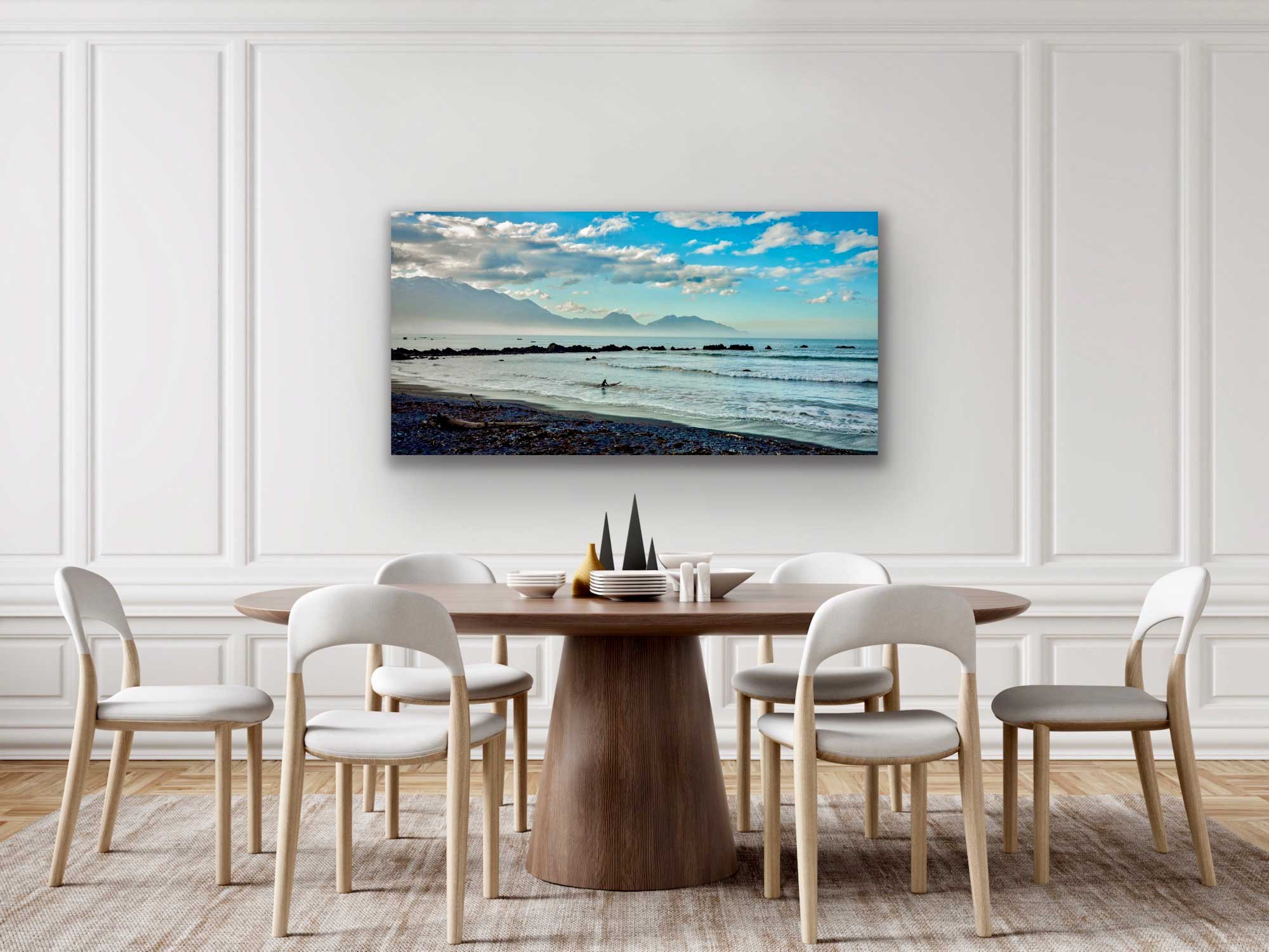 Kaikoura surfer photograph in situ. Blue tone photograph on wall above dining table. See interior design artwork.